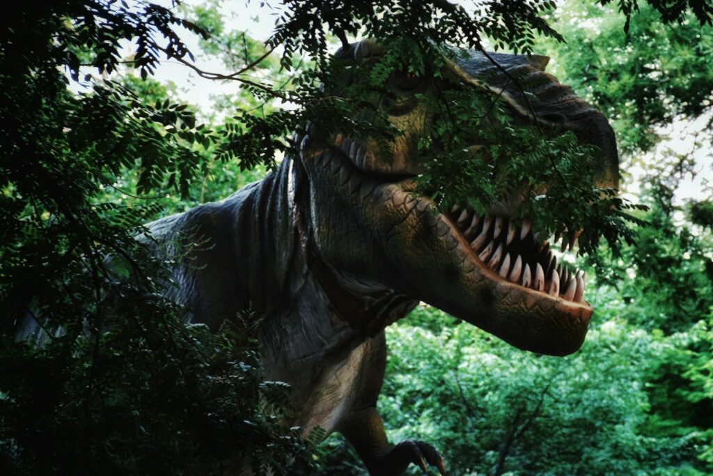 A tyrannosaurus rex lurks within lush foliage.