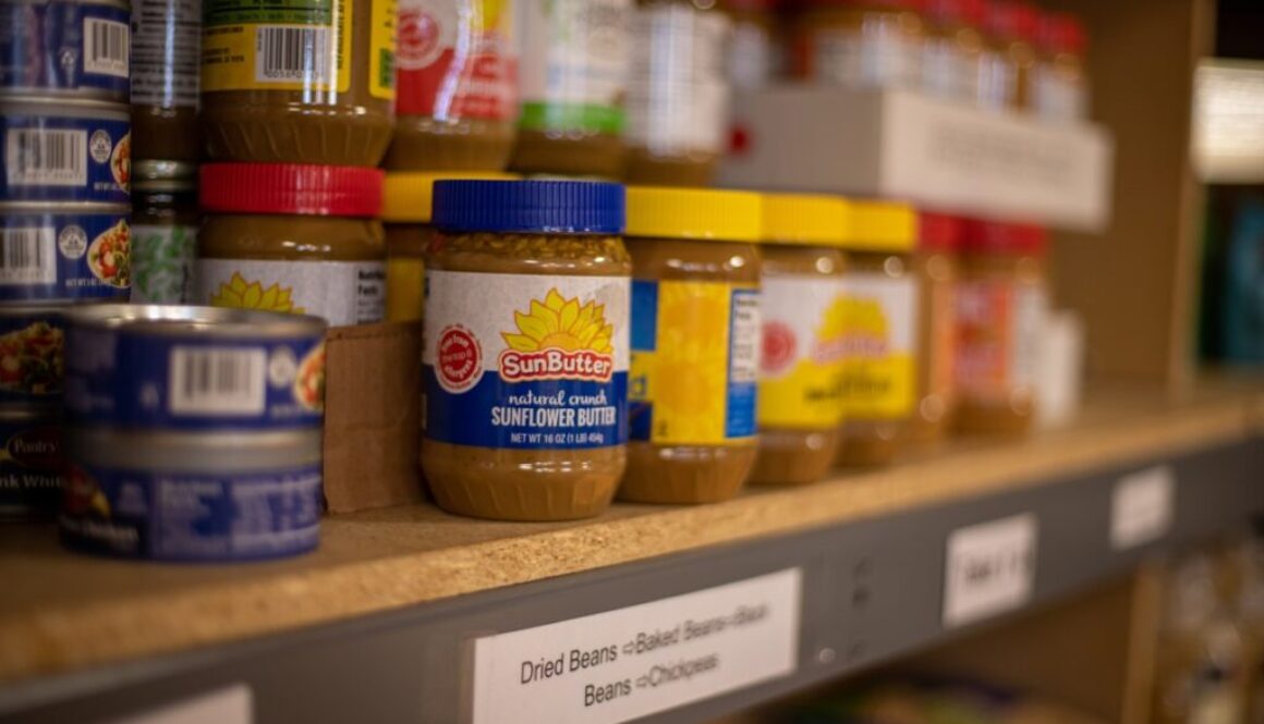 assorted plastic containers on brown wooden shelf