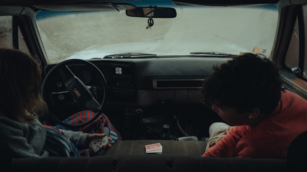 a couple of women sitting inside of a car