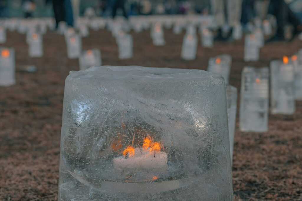 a group of candles sitting inside of an ice block