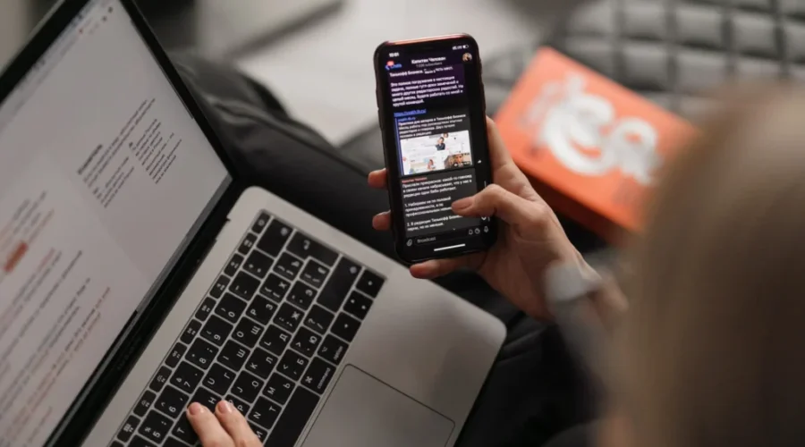 person holding black iphone 4 Finding Internet and cellphone services availability across Canada