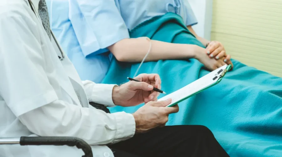 Doctor in professional uniform examining patient at hospital or medical clinic. Health care , medical and doctor staff service concept. NDP dismisses government’s enthusiasm over Primary Care Action Plan