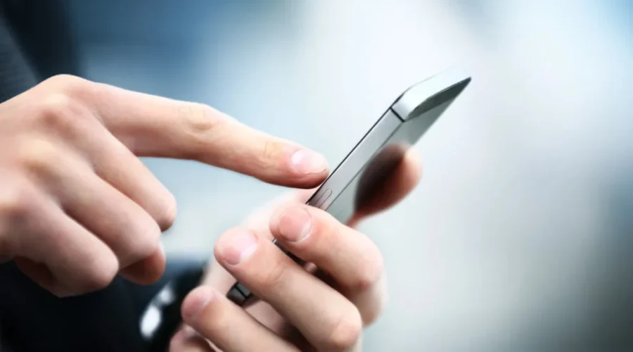 Close up of a man using mobile smart phone Feds put $102M into 9-8-8 suicide hotline