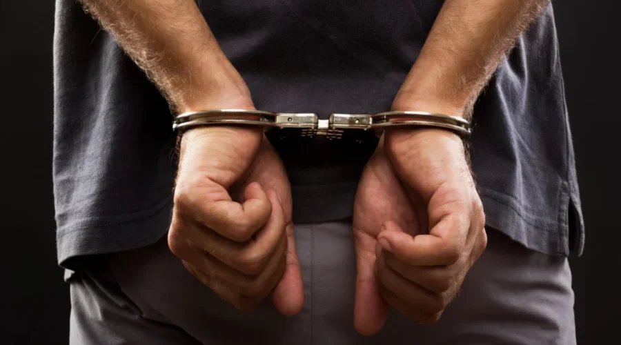 Close-up. Arrested man handcuffed Bail violation investigation leads to drug charge