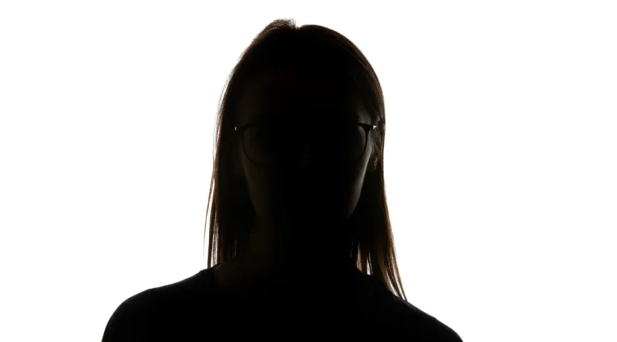 Silhouette of woman in glasses looking at camera isolated on white New pilot could help more victims of intimate partner violence