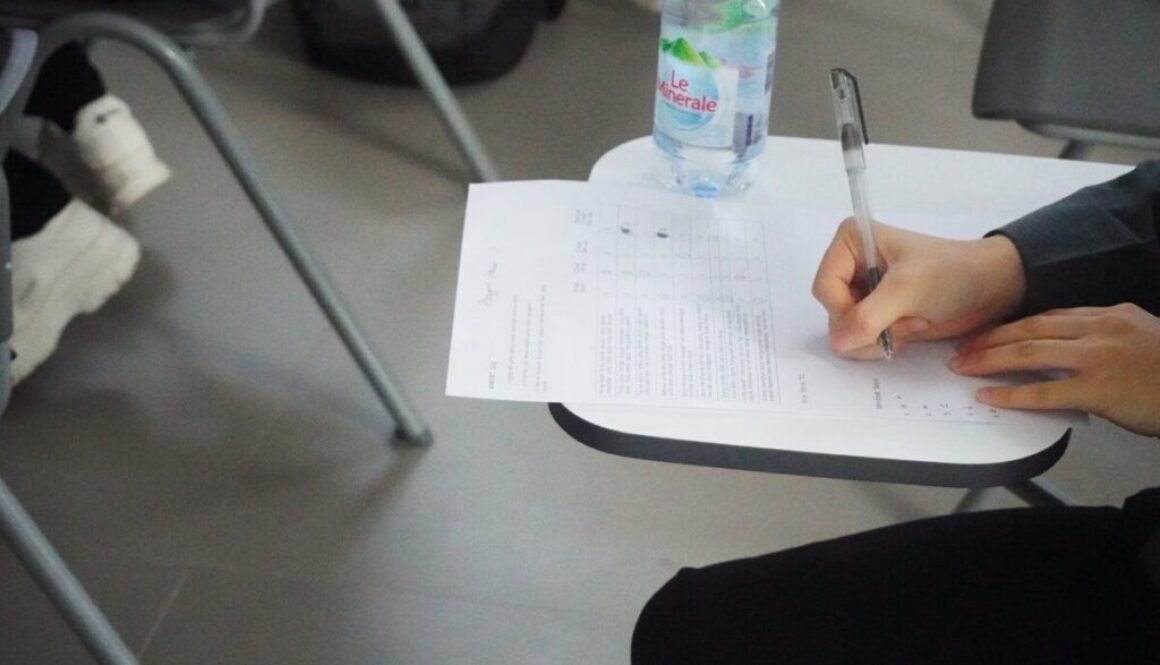 a person writing on a piece of paper