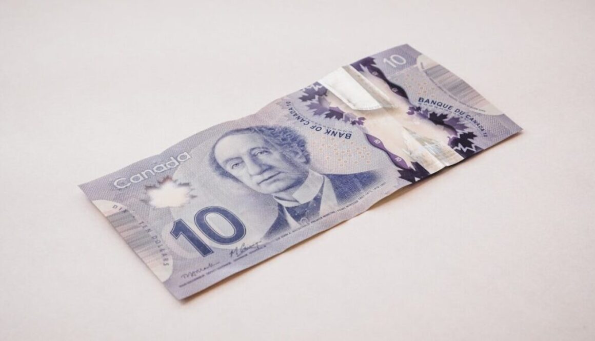 a ten dollar bill with a piece of tape sticking out of it