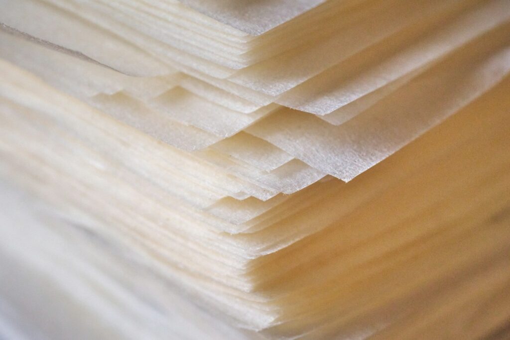 Sheets of thin, translucent paper stacked together.